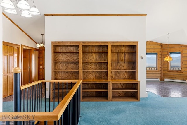 2 Eight Mile Creek Rd, Ennis, MT 59729 - corridor with a chandelier, a baseboard radiator, an upstairs landing, carpet flooring, and wood walls
