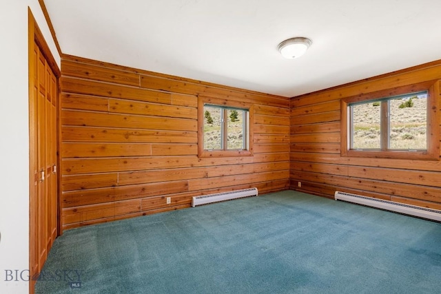 2 Eight Mile Creek Rd, Ennis, MT 59729 - spare room featuring a baseboard heating unit, carpet floors, and wood walls