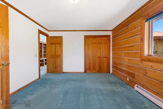 2 Eight Mile Creek Rd, Ennis, MT 59729 - unfurnished bedroom featuring a baseboard radiator, carpet, ornamental molding, a closet, and wood walls