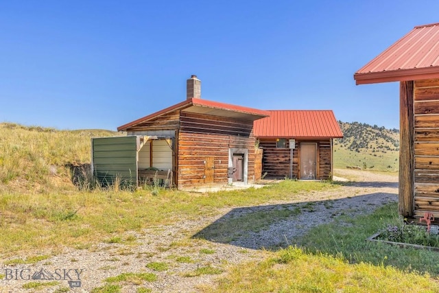 2 Eight Mile Creek Rd, Ennis, MT 59729 - rear view of property with a metal roof and a chimney