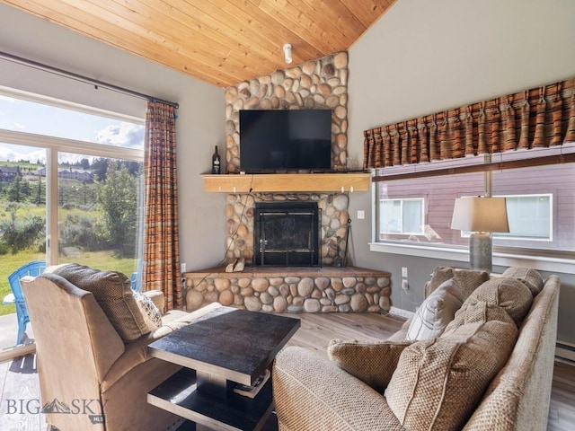 417 Firelight, Big Sky, MT 59716 - living room featuring lofted ceiling, wood finished floors, healthy amount of natural light, a stone fireplace, and wood ceiling