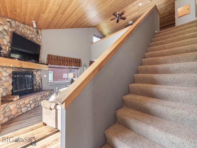 417 Firelight, Big Sky, MT 59716 - staircase with a stone fireplace, wood finished floors, ceiling fan, lofted ceiling, and wooden ceiling