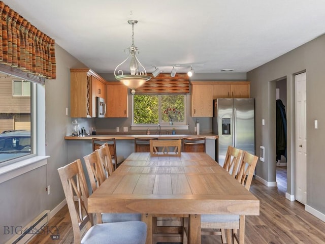 417 Firelight, Big Sky, MT 59716 - dining area featuring a baseboard heating unit and wood finished floors