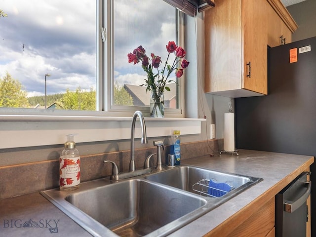 417 Firelight, Big Sky, MT 59716 - kitchen with stainless steel dishwasher and brown cabinetry