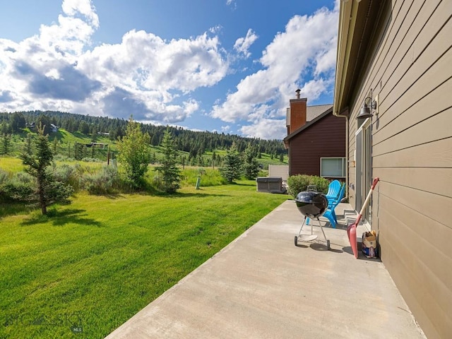 417 Firelight, Big Sky, MT 59716 - view of grassy yard with a patio and a view of trees