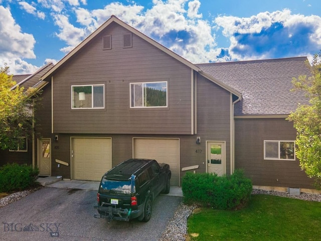 417 Firelight, Big Sky, MT 59716 - view of front facade with driveway and an attached garage