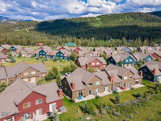 417 Firelight, Big Sky, MT 59716 - aerial view of residential area with a forest and a mountainous background