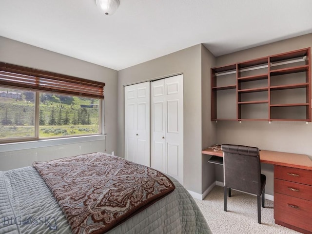 417 Firelight, Big Sky, MT 59716 - bedroom featuring light colored carpet, built in desk, and a closet