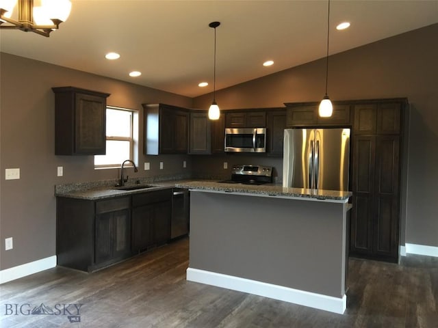 639 Avon Cir, Butte, MT 59701 - kitchen featuring appliances with stainless steel finishes, lofted ceiling, a center island, dark brown cabinetry, and stone countertops