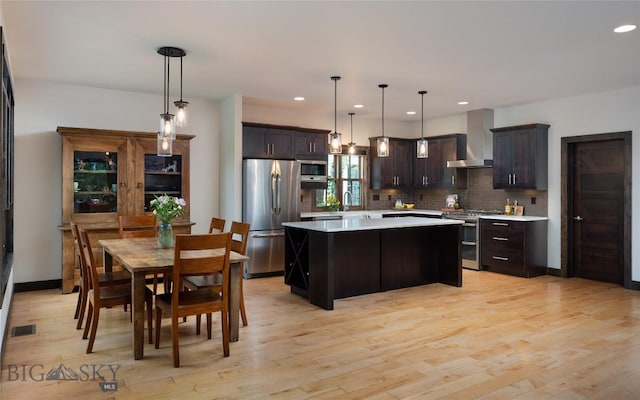 89 W Fieldview St, Bozeman, MT 59715 - kitchen with stainless steel appliances, wall chimney range hood, light countertops, tasteful backsplash, and a kitchen island