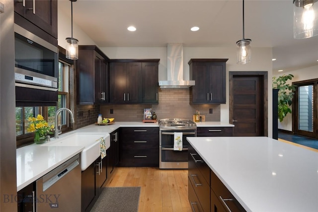 89 W Fieldview St, Bozeman, MT 59715 - kitchen featuring stainless steel appliances, wall chimney range hood, plenty of natural light, light wood-style flooring, and recessed lighting