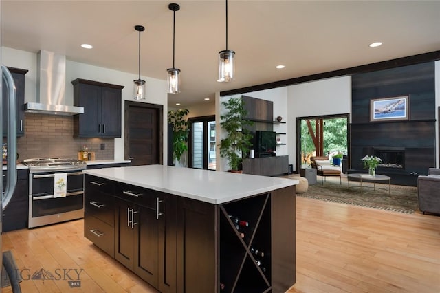 89 W Fieldview St, Bozeman, MT 59715 - kitchen with range with two ovens, wall chimney range hood, open floor plan, light countertops, and recessed lighting