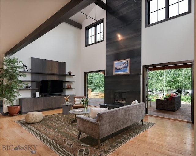 89 W Fieldview St, Bozeman, MT 59715 - living room with high vaulted ceiling, beamed ceiling, a fireplace, light wood-style flooring, and healthy amount of natural light