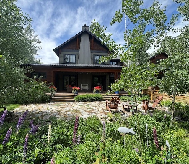 89 W Fieldview St, Bozeman, MT 59715 - back of house with a chimney, a metal roof, and a porch