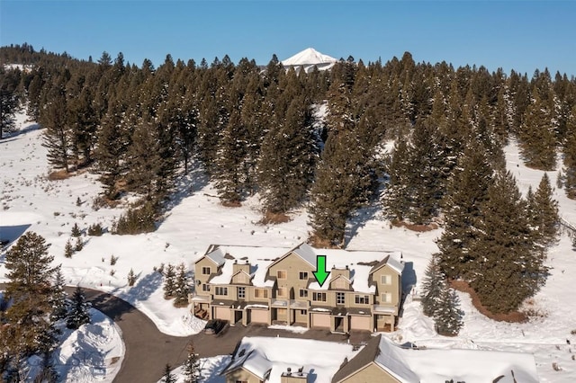 15 Spotted Fawn Ct, Big Sky, MT 59716 - snowy aerial view featuring a forest view
