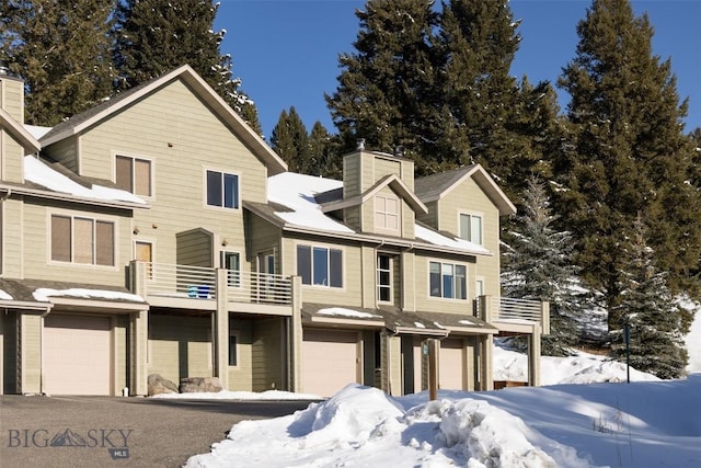 15 Spotted Fawn Ct, Big Sky, MT 59716 - view of front of home with a balcony, a chimney, and a garage
