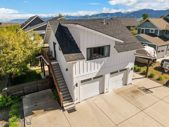 4412 Bembrick St, Bozeman, MT 59718 - view of home's exterior featuring board and batten siding, stairs, a shingled roof, and a mountain view