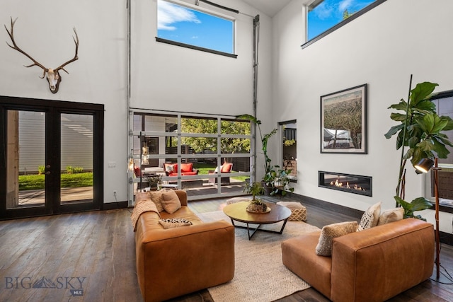 4412 Bembrick St, Bozeman, MT 59718 - living area featuring a high ceiling, a glass covered fireplace, hardwood / wood-style floors, and french doors