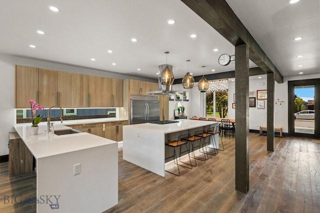 4412 Bembrick St, Bozeman, MT 59718 - kitchen with built in refrigerator, a kitchen breakfast bar, gas cooktop, light countertops, and recessed lighting
