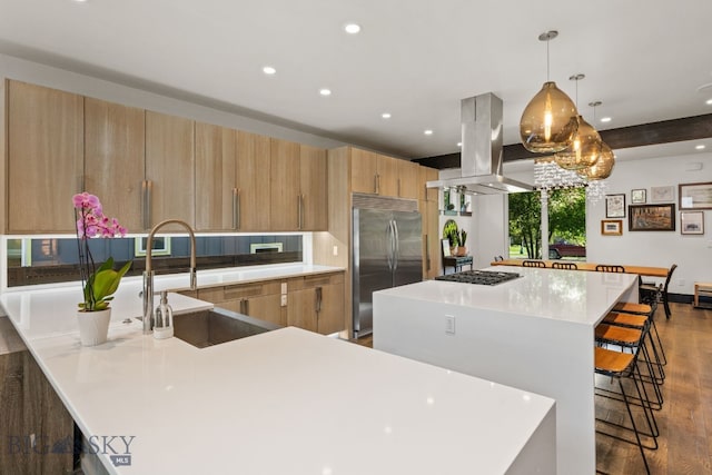 4412 Bembrick St, Bozeman, MT 59718 - kitchen with stainless steel appliances, island exhaust hood, wood finished floors, recessed lighting, and a breakfast bar
