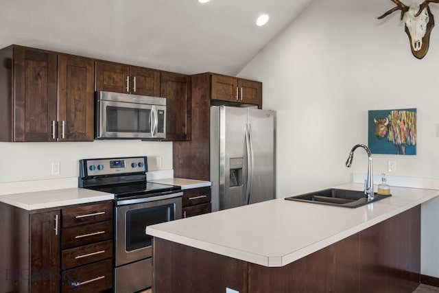 4412 Bembrick St, Bozeman, MT 59718 - kitchen featuring appliances with stainless steel finishes, vaulted ceiling, light countertops, dark brown cabinetry, and recessed lighting