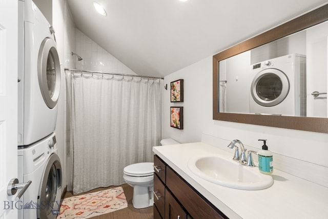 4412 Bembrick St, Bozeman, MT 59718 - bathroom featuring stacked washer / dryer, vaulted ceiling, vanity, and wood finished floors