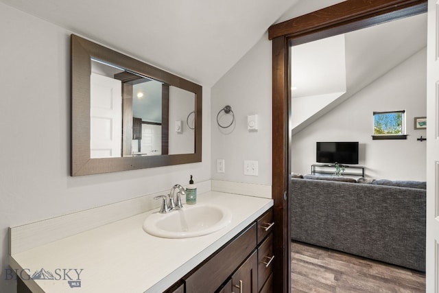 4412 Bembrick St, Bozeman, MT 59718 - bathroom with vaulted ceiling, wood finished floors, and vanity