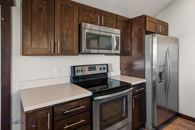 4412 Bembrick St, Bozeman, MT 59718 - kitchen featuring stainless steel appliances, light countertops, and dark brown cabinetry