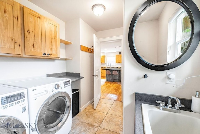 4619 Cascade St, Bozeman, MT 59718 - washroom featuring washing machine and dryer, light tile patterned floors, and cabinet space