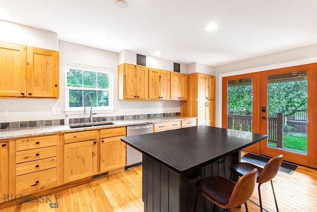 4619 Cascade St, Bozeman, MT 59718 - kitchen featuring dishwasher, healthy amount of natural light, a kitchen breakfast bar, light wood-type flooring, and recessed lighting
