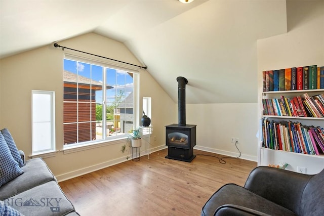 4619 Cascade St, Bozeman, MT 59718 - living area featuring wood finished floors, lofted ceiling, and a wood stove