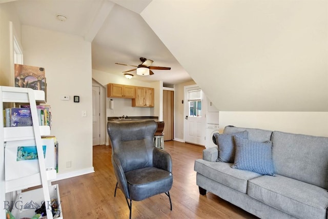4619 Cascade St, Bozeman, MT 59718 - living area featuring light wood-type flooring, ceiling fan, stacked washing machine and dryer, and vaulted ceiling