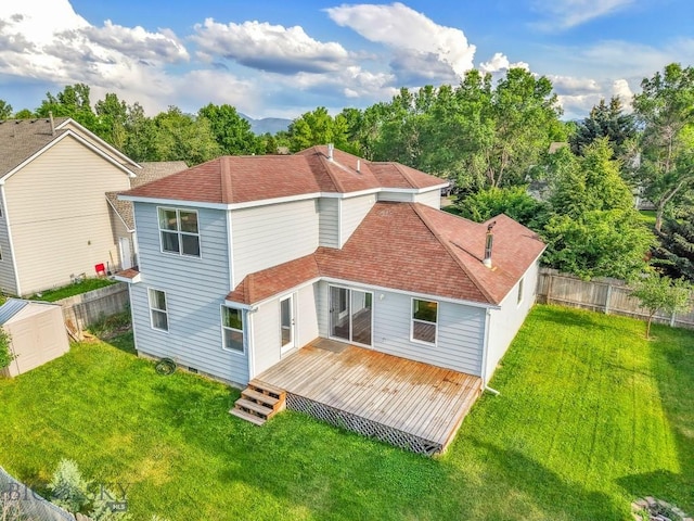 3601 Ravalli St, Bozeman, MT 59718 - back of property with a fenced backyard, a deck, a storage unit, and roof with shingles