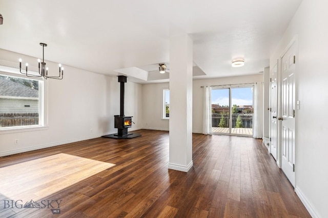 3601 Ravalli St, Bozeman, MT 59718 - unfurnished living room with a wood stove, dark wood-style floors, a chandelier, and ceiling fan