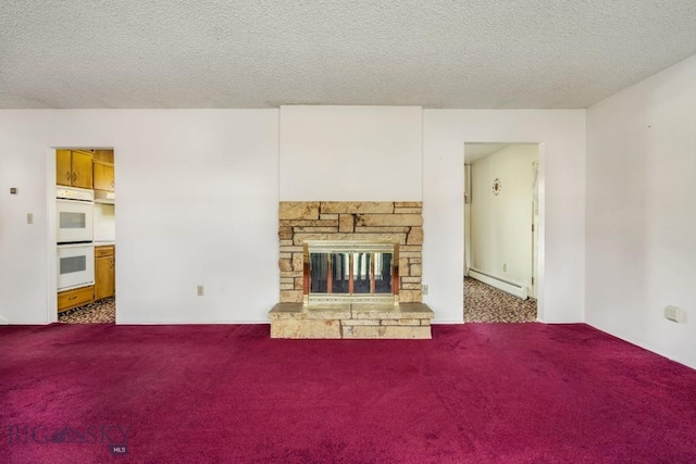 1721 S Willson Ave, Bozeman, MT 59715 - unfurnished living room featuring a baseboard heating unit, carpet floors, a textured ceiling, and a fireplace