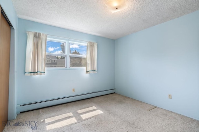 1721 S Willson Ave, Bozeman, MT 59715 - carpeted empty room featuring a baseboard radiator and a textured ceiling