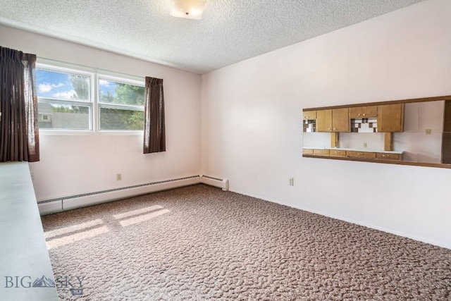 1721 S Willson Ave, Bozeman, MT 59715 - empty room featuring a baseboard radiator, carpet, and a textured ceiling