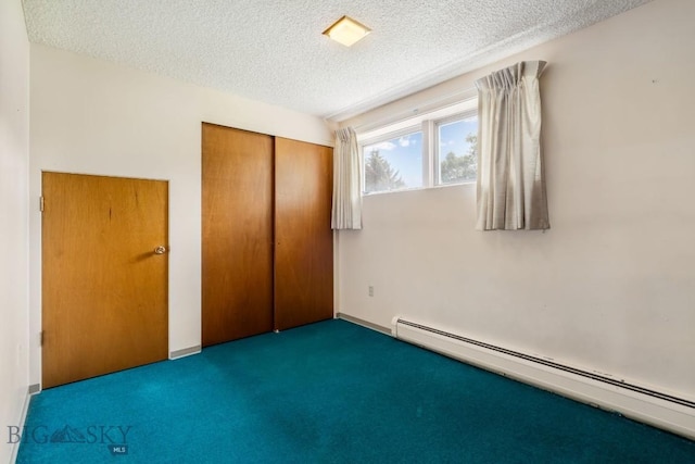 1721 S Willson Ave, Bozeman, MT 59715 - unfurnished bedroom featuring baseboard heating, carpet, a textured ceiling, and a closet