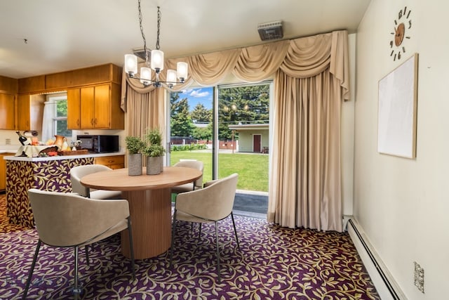 1721 S Willson Ave, Bozeman, MT 59715 - dining area with a baseboard radiator, a chandelier, healthy amount of natural light, and dark colored carpet