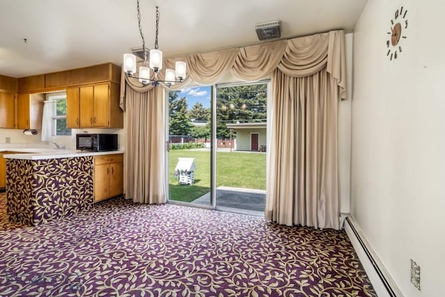1721 S Willson Ave, Bozeman, MT 59715 - kitchen featuring a baseboard heating unit, a chandelier, carpet floors, and black microwave