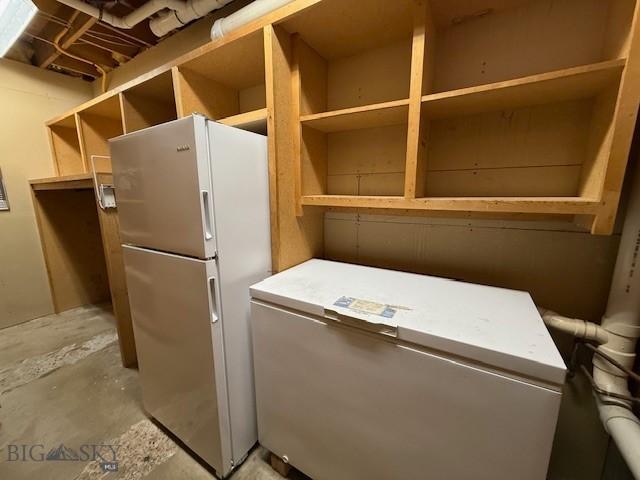 1416 W Gold St, Butte, MT 59701 - kitchen featuring freestanding refrigerator, open shelves, refrigerator, and concrete flooring