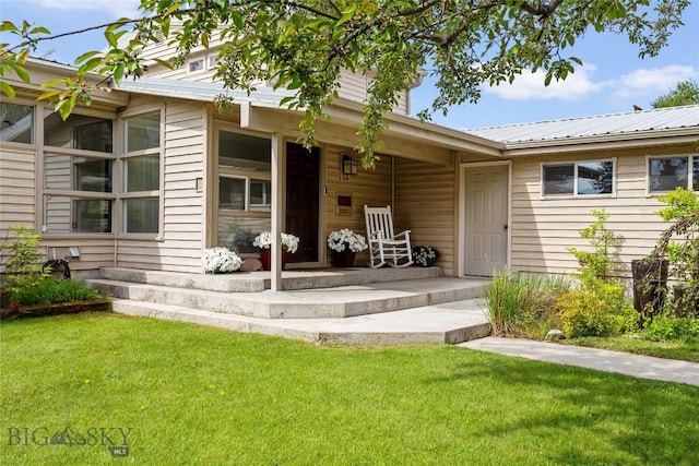 1416 W Gold St, Butte, MT 59701 - view of exterior entry featuring a lawn, a metal roof, and covered porch