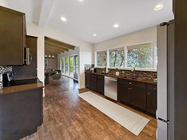 1416 W Gold St, Butte, MT 59701 - kitchen featuring appliances with stainless steel finishes, beam ceiling, decorative backsplash, dark wood-type flooring, and dark brown cabinetry