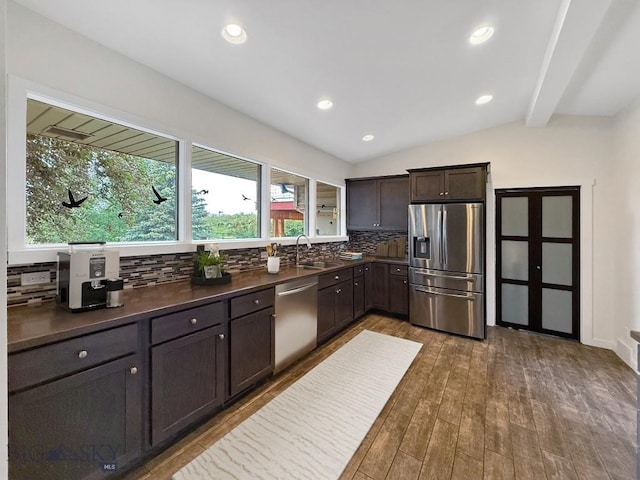 1416 W Gold St, Butte, MT 59701 - kitchen featuring appliances with stainless steel finishes, dark countertops, decorative backsplash, dark wood-style flooring, and dark brown cabinets