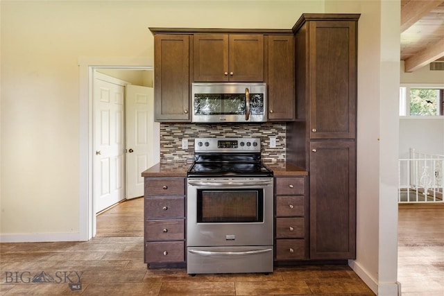 1416 W Gold St, Butte, MT 59701 - kitchen with stainless steel appliances, dark countertops, dark wood-style floors, and decorative backsplash