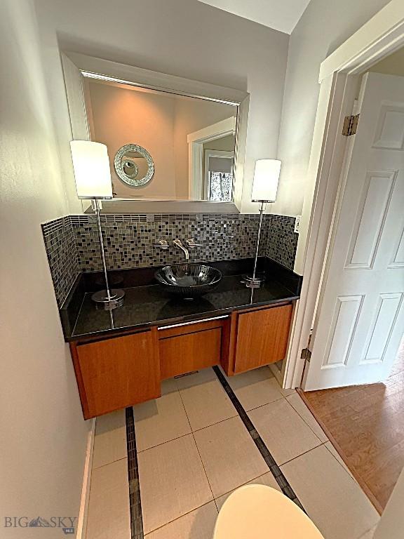 1416 W Gold St, Butte, MT 59701 - bathroom featuring tile patterned floors, decorative backsplash, and vanity