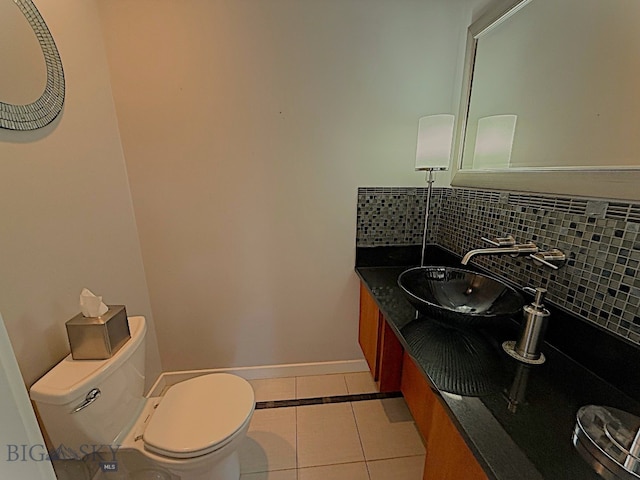 1416 W Gold St, Butte, MT 59701 - half bathroom with tile patterned floors, vanity, and decorative backsplash