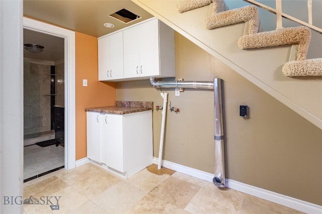 1416 W Gold St, Butte, MT 59701 - washroom featuring cabinet space and baseboards