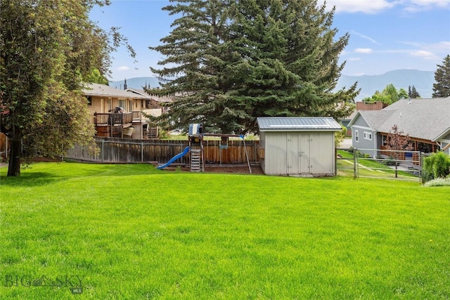 1416 W Gold St, Butte, MT 59701 - fenced backyard with a shed, a playground, and a mountain view