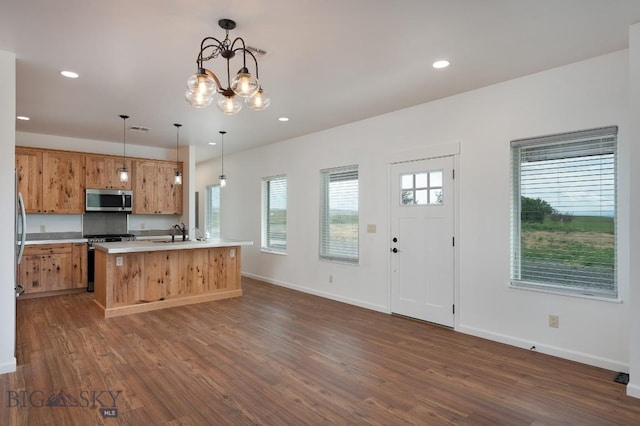375 Price Rd, Three Forks, MT 59752 - kitchen featuring stainless steel appliances, dark wood-type flooring, light countertops, recessed lighting, and a kitchen island with sink